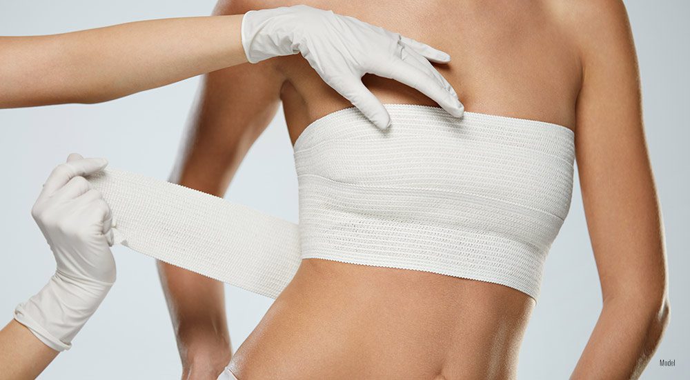 female after breast removal with bandage around her breast 